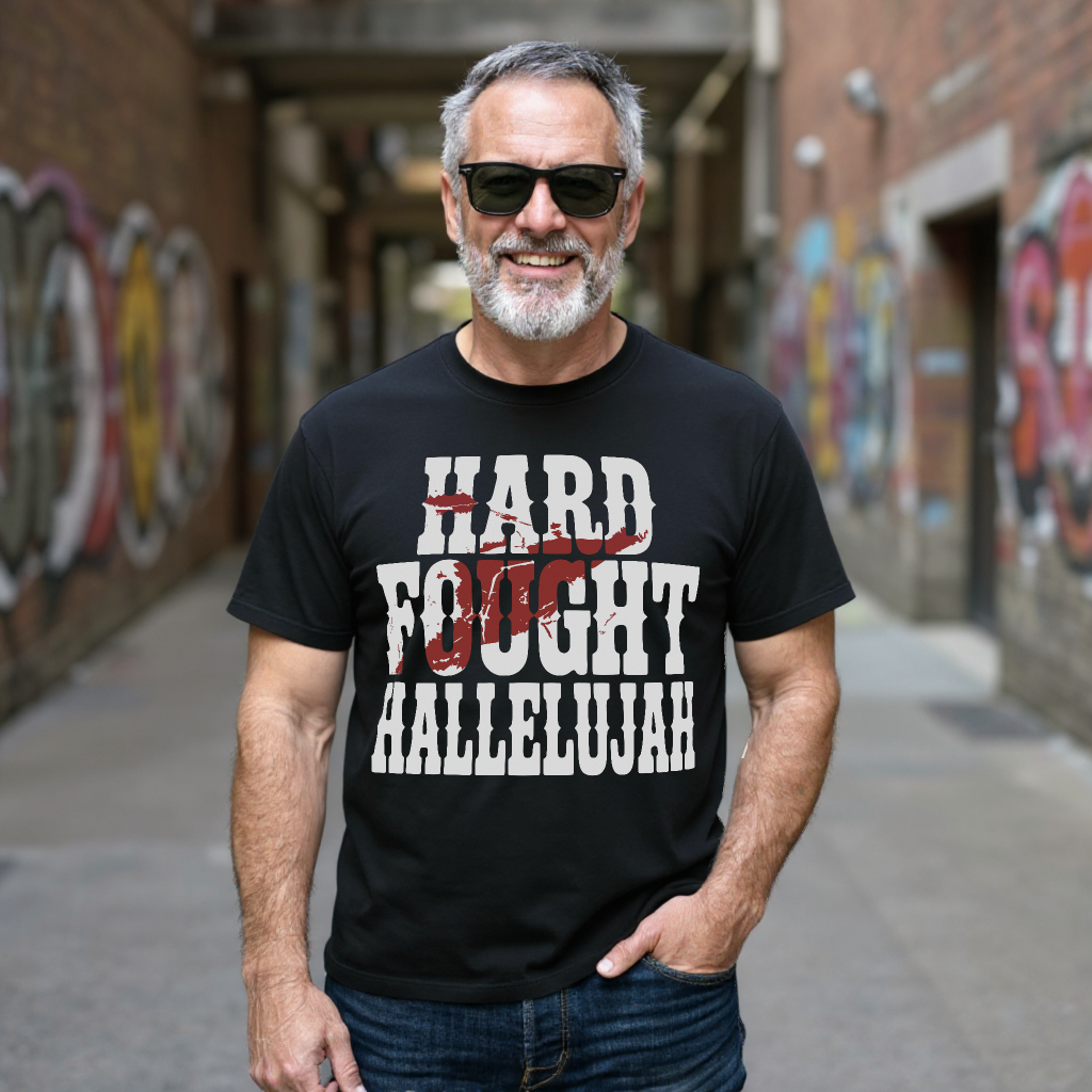 Salt and Light Merch black t-shirt with 'HARD FOUGHT HALLELUJAH' text in an alleyway with graffiti.