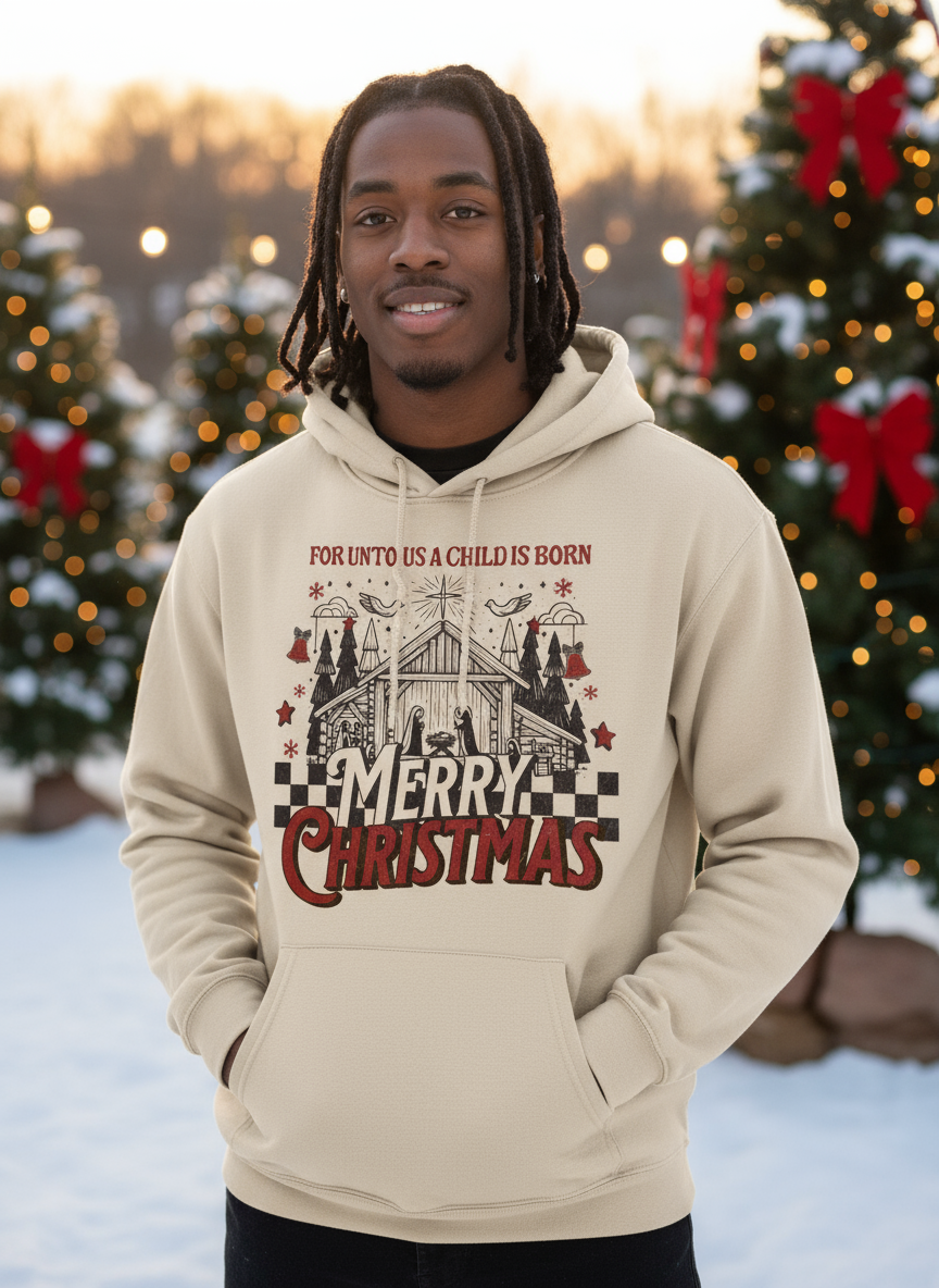 Salt and Light Merch Person wearing a beige hoodie with Christmas design in a snowy outdoor setting with decorated trees.