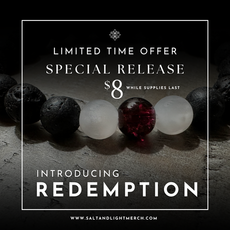 Redemption Christian Bracelet with black lava stone beads, frosted white beads, and a deep red centerpiece bead – faith jewelry by Salt and Light Merch.