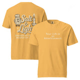 Double-sided mustard Comfort Colors Christian t-shirt showing ‘Your life is an Advertisement’ on the front and retro Salt & Light graphic with ‘Shaker of Grace, Bearer of Light’ on the back. Salt and Light Merch