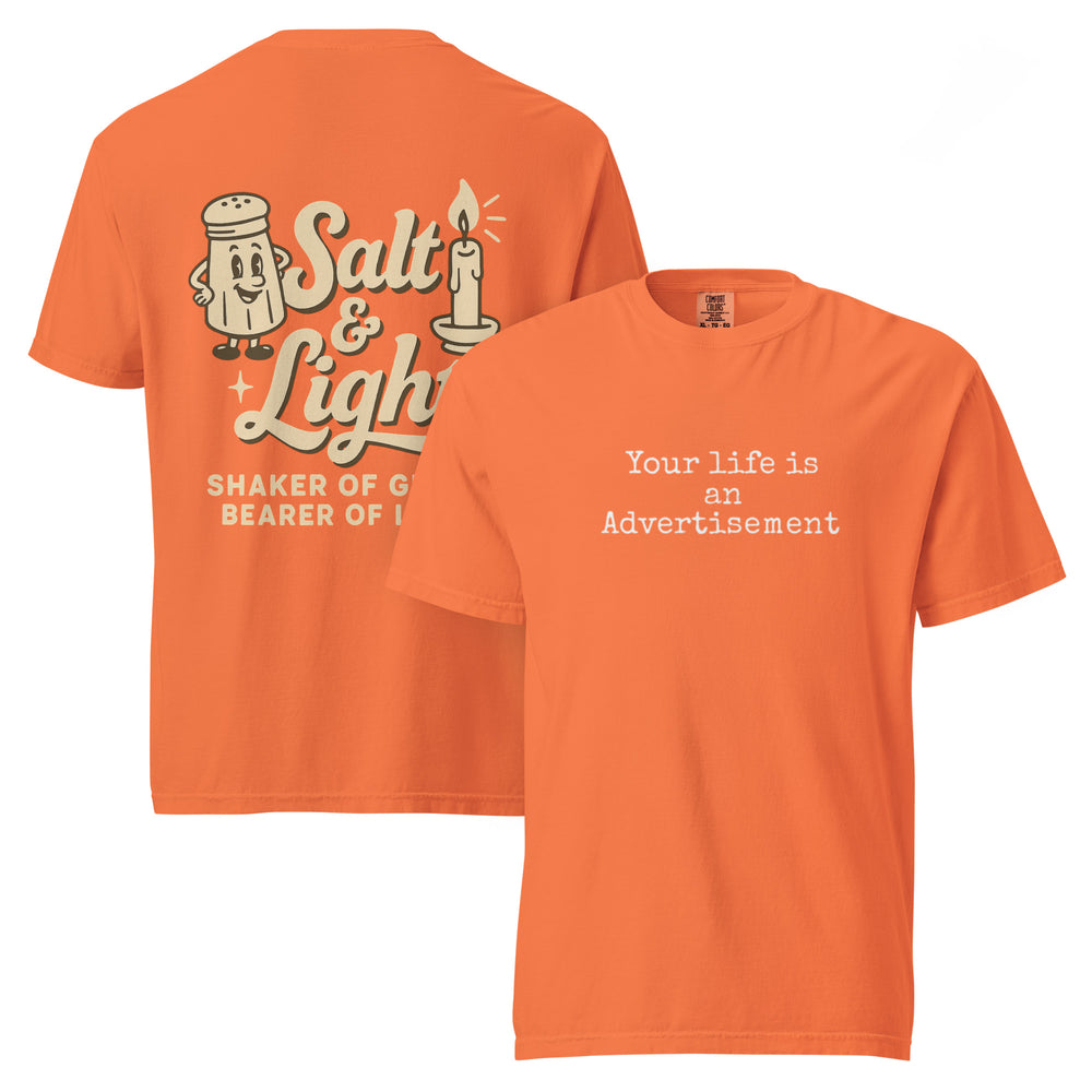 Double-sided Burnt Orange Comfort Colors Christian t-shirt showing ‘Your life is an Advertisement’ on the front and retro Salt & Light graphic with ‘Shaker of Grace, Bearer of Light’ on the back. Salt and Light Merch