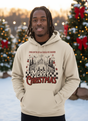 Salt and Light Merch Person wearing a beige hoodie with Christmas design in a snowy outdoor setting with decorated trees.