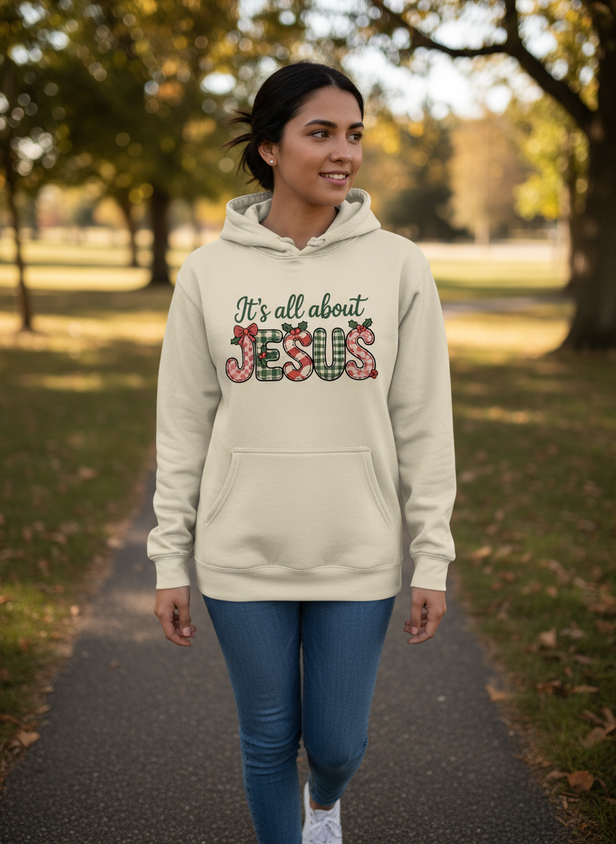 Salt and Light Merch Christmas Hoodie Woman wearing a hoodie with 'It's all about Jesus' text in a park