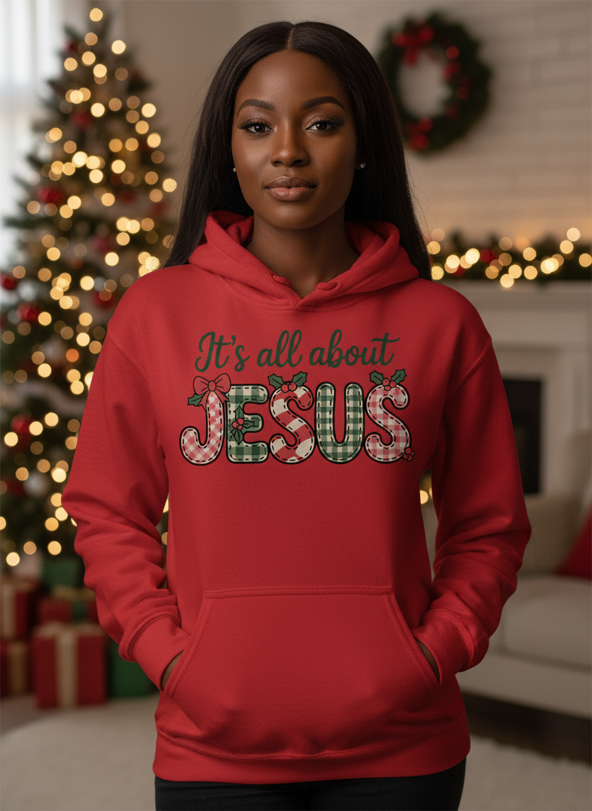 Salt and Light Merch Christmas Hoodie Person wearing a red hoodie with 'It's all about Jesus' text in a decorated room.