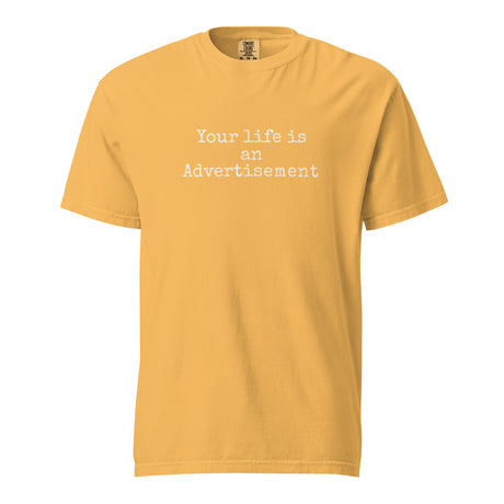 Mustard Comfort Colors Christian t-shirt with the phrase ‘Your life is an Advertisement’ in simple white typewriter font on the front. Salt and Light Merch